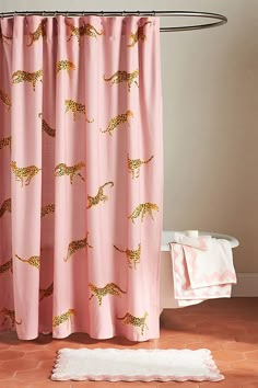 a pink shower curtain with gold cheetah on it