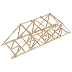 a wooden structure that has been made out of sticks and is sitting on a white surface