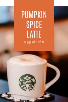 the pumpkin spice latte is served in a white coffee cup on a black saucer