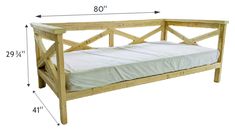 a wooden day bed with white sheets and measurements