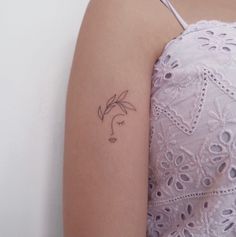 a woman with a small tattoo on her arm