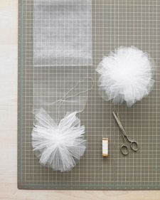 scissors and tulle sitting on top of a cutting board