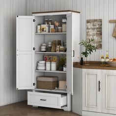 an open cabinet in the corner of a kitchen with white cupboards and drawers on both sides