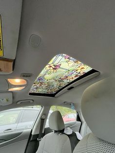 the interior of a car with a stained glass skylight in the back seat and sunroof