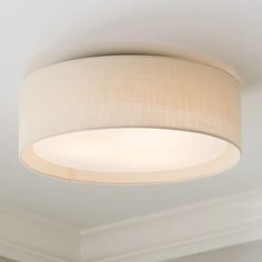 a light fixture in a room with white walls and carpeted flooring on the ceiling