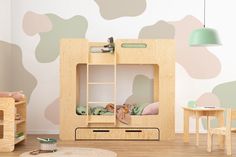 a child's room with wooden furniture and walls painted in pastel colors, including camouflage