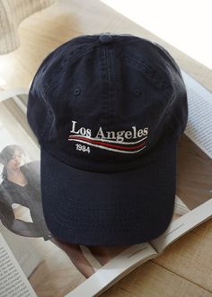 Our embroidered Los Angeles baseball hat is the perfect accessory for the girl on the go that is running errands, going on a hike or just wants to complete the outfit with the perfect accessory. One Size fits all with adjustable strap. Color: Navy All accessories are Final Sale - No Returns No Exchanges. Trendy Baseball Cap For Travel, Casual Snapback Hat With Letter Embroidery, Casual Travel Baseball Cap One Size, Vintage Adjustable Dad Hat For Everyday, Casual Cotton Hat For Travel, Casual Travel Hat, Casual Snapback Hat With Letter Embroidery For Baseball Season, Trendy Snapback Baseball Cap For Outdoor Activities, Casual Baseball Cap With Embroidered Logo For Outdoor