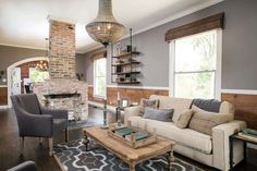 a living room filled with furniture and a fire place