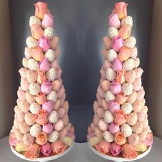 there are two tall cakes with flowers on the top one is made out of pink and white roses