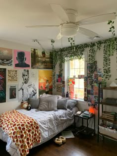 a bed sitting in a bedroom next to a window with lots of pictures on the wall