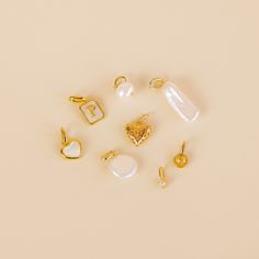 there are many different types of earrings on the table, including one with a heart