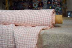 a roll of fabric sitting on top of a bed