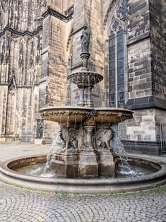 an old building with a fountain in front of it