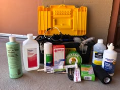 an assortment of cleaning products sitting on the floor next to a toolbox and window