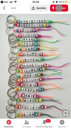 a bunch of key chains that are all different colors and sizes with words written on them