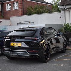 a black sports car parked in a parking lot