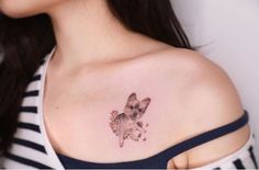 a woman with a small dog tattoo on her shoulder