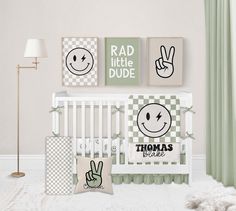 a baby's room with green and white decor, including two wall hangings