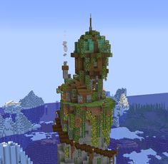 a very tall tower with lots of plants on it in the middle of an ocean