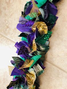 a close up of a wreath on the ground with ribbons attached to it's sides