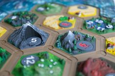 a close up of a board game with mountains and trees