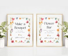 two flower bar signs with flowers in vases