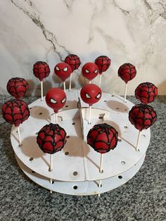 cake pops with spiderman faces on them are ready to be cut and served for guests