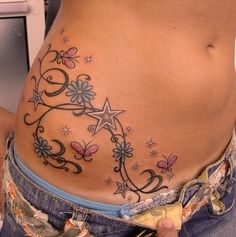 a woman's stomach with flowers and stars on it