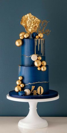 a blue cake with gold decorations on top and the number forty one written on it