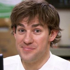 a man in a white shirt and tie is looking at the camera with a surprised look on his face