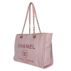 Authentic NEW Chanel Deauville pink canvas large shopping tote. The bag can be carried on the handle or worn over the shoulder. Features pink woven leather shoulder straps, top center snap closure, gold-tone hardware, two interior slip pockets and a zip pocket, Chanel Paris logo on the front exterior, and pink interior lining. Made in Italy 2020 Hologram stamp and the card read: 30163798 Handle drop: 4.5" Strap drop: 10.5" Chanel Cambon, Paris Logo, Pink Canvas, Pink Interior, Chanel Paris, Chanel Deauville Tote Bag, Bag Packaging, Shopping Tote, Canvas Leather