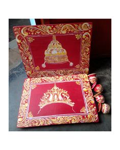 two red boxes with gold designs on them