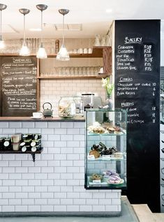 a small bakery with chalkboard menus on the wall