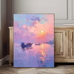 a painting on the wall next to a cabinet with a boat in the water at sunset