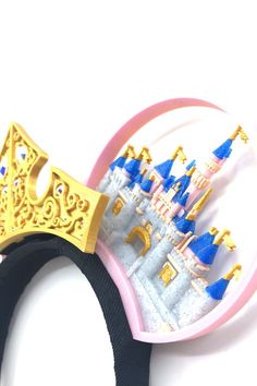 a close up of a mouse's head with a castle in the middle and blue turrets on it