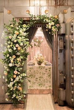 an archway decorated with flowers and greenery