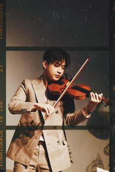 a man in a suit playing the violin