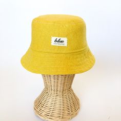 This yellow bucket hat is the perfect thing for babies toddlers and kids on sunny summer days! Washable linen and cotton fabirc makes it an easy go to for at the park, the beach, or even the backyard! This hat will protect delicate skin from the sun and will quickly become a favorite accessory! I made this sun hat from a bold yellow colored linen/cotton blend fabric. The strap closes with snaps under the chin keeps them from pulling it off. Brim measures approx. 2.25 inches. SIZES AVAILABLE 0-3 mos. - fits 14" to 16" head circumference 3-6 mos. - fits 15" to 17" head circumference 6-12 mos. - fits 16" to 18" head circumference 12-24 mos. - fits 17.5" to 19.5" head circumference Small (3 to 5 yrs) - fits 19" to 21" head circumference OVERVIEW + Sewn by me + Yellow Linen and Cotton blend Fab