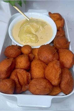 a white container filled with tater tots and dipping sauce