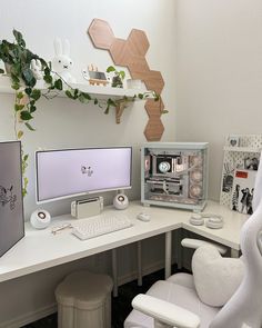 a white desk topped with two computer monitors and a desktop monitor on top of it