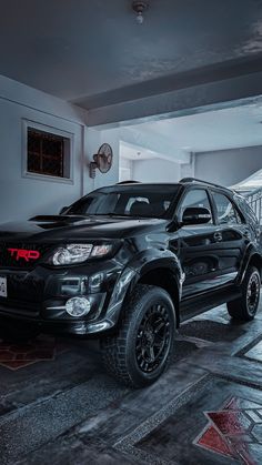 a black truck is parked in a garage