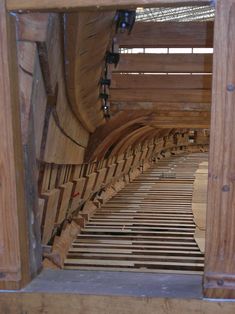 the inside of a building with wooden slats