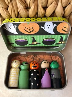 an open tin box filled with halloween decorations