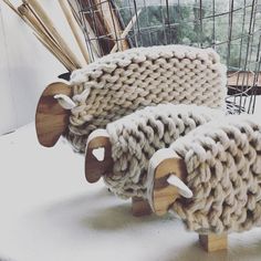 two sheep made out of yarn sitting next to each other on a white counter top