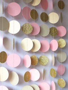 pink, gold and white paper circles hanging from strings