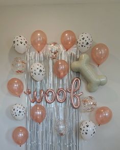 balloons and confetti are arranged around the word woof