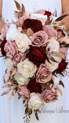 a bride holding a bouquet of flowers in her hands