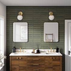 a bathroom with two sinks and mirrors on the wall