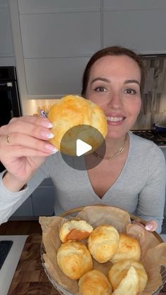 a woman sitting at a table with a bowl of food in front of her and a video showing how to make biscuits