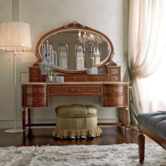 a dressing table with a mirror and stool in a room